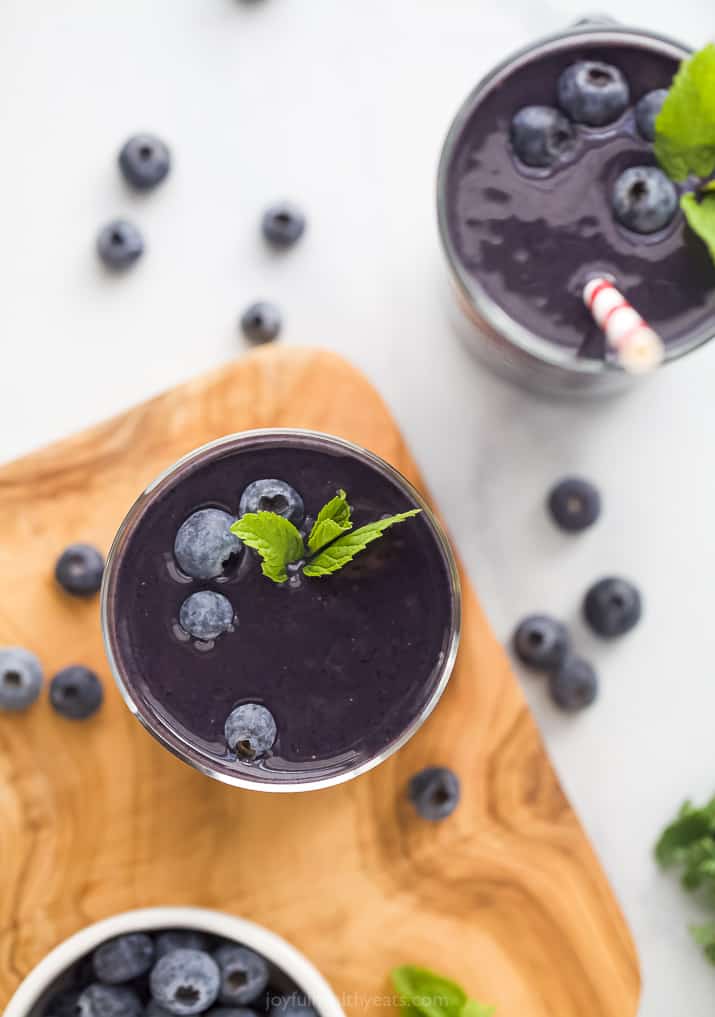 A Cup of Kale Smoothie on a Wooden Cutting Board