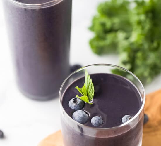A Tall and a Short Glass Containing Blueberry Kale Smoothies