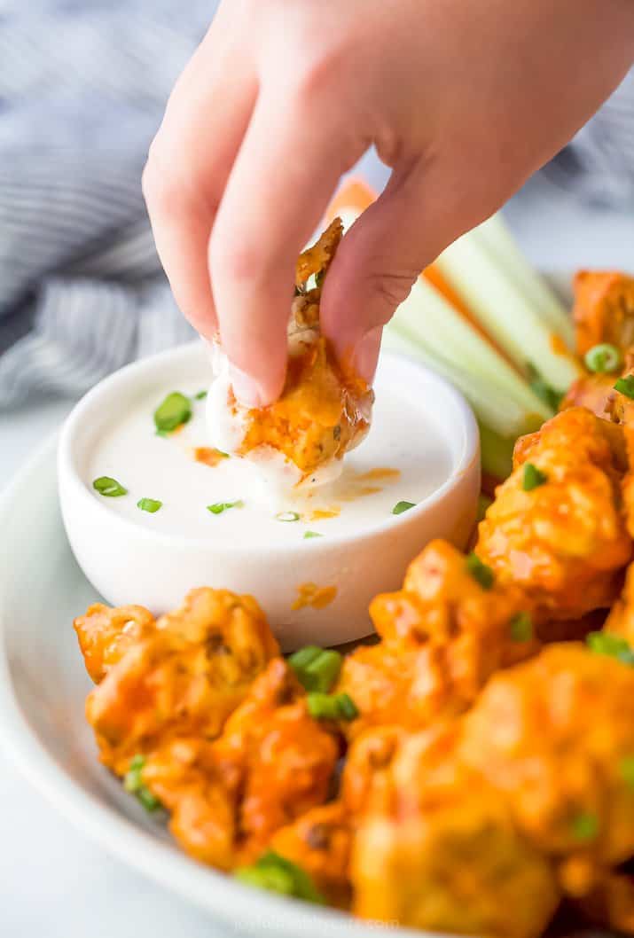 A Cauliflower Wing Being Dunked in Ranch