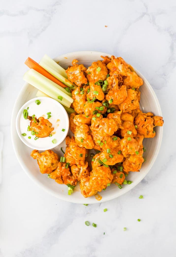 A Bowl Filled with Buffalo Cauliflower Bites, Ranch and Raw Veggies