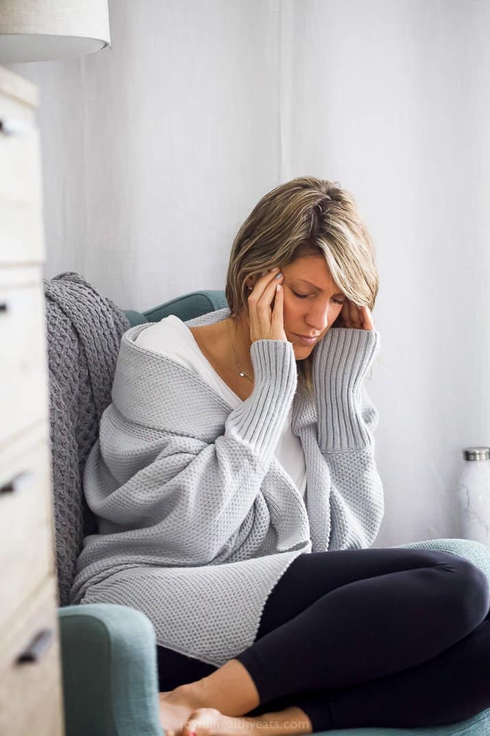 girl holding her head from headache pain