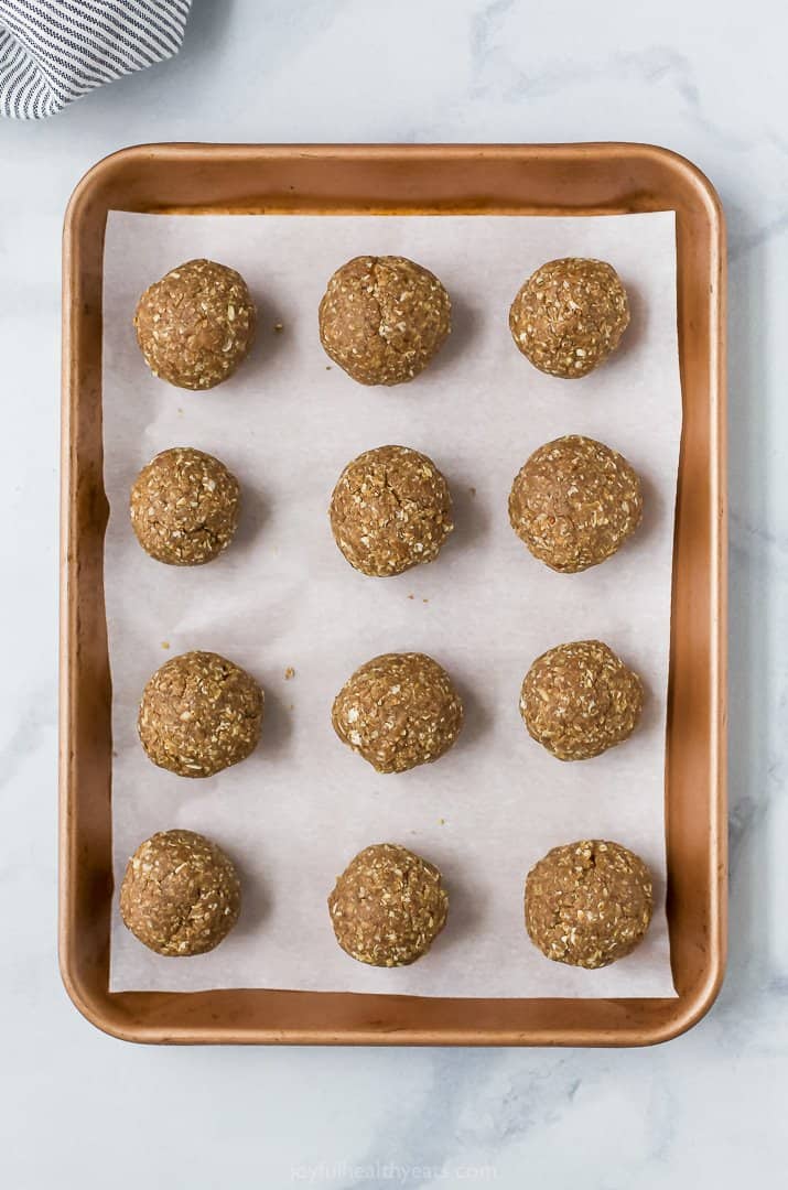 rolled energy bites on a baking sheet