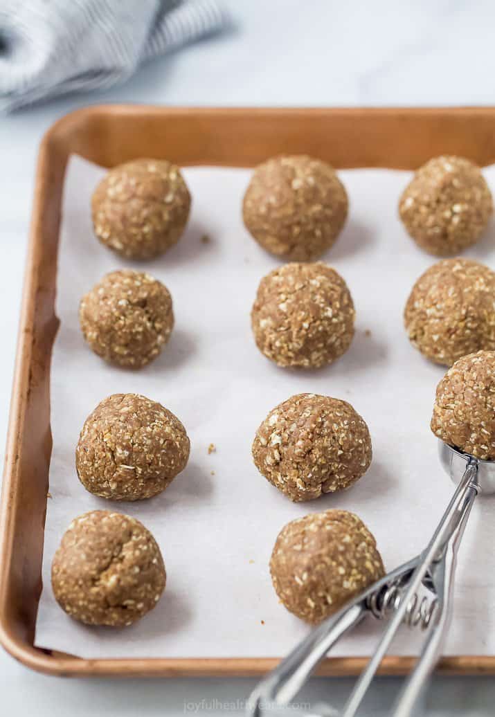 scoop on a baking sheet holding an energy ball