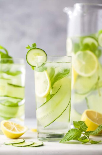 glass filled with lemon water and cucumbers