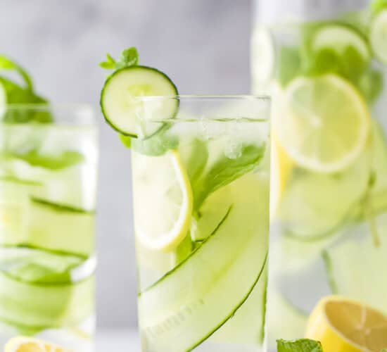 glass filled with lemon water and cucumbers