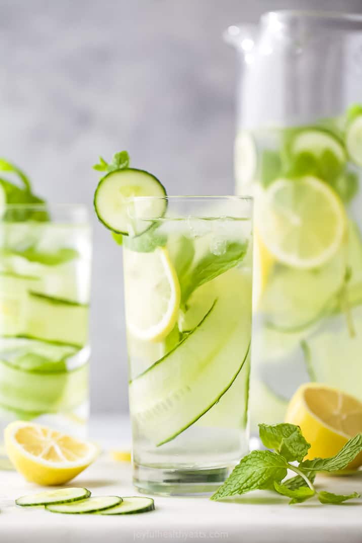 glass filled with lemon water and cucumbers