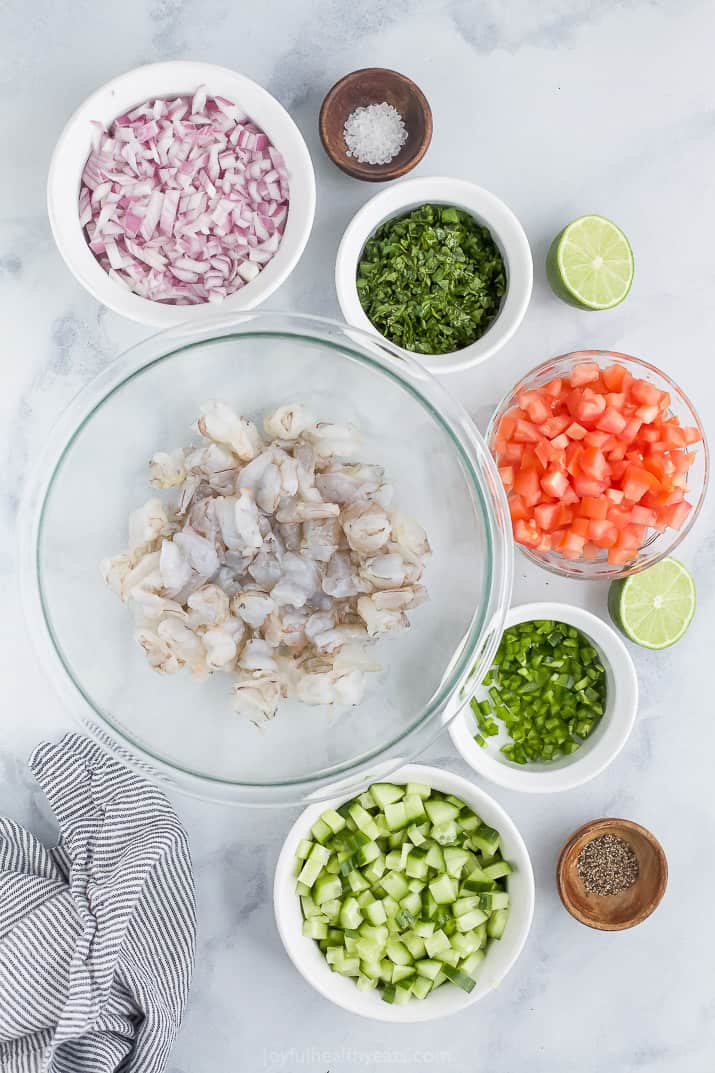 Bowls Containing Each Shrimp Ceviche Ingredient on a Pale Countertop