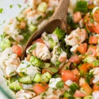 A Close-Up Image of Ceviche Being Gently Stirred with a Spoon