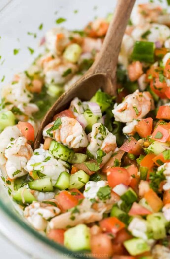 A Close-Up Image of Ceviche Being Gently Stirred with a Spoon