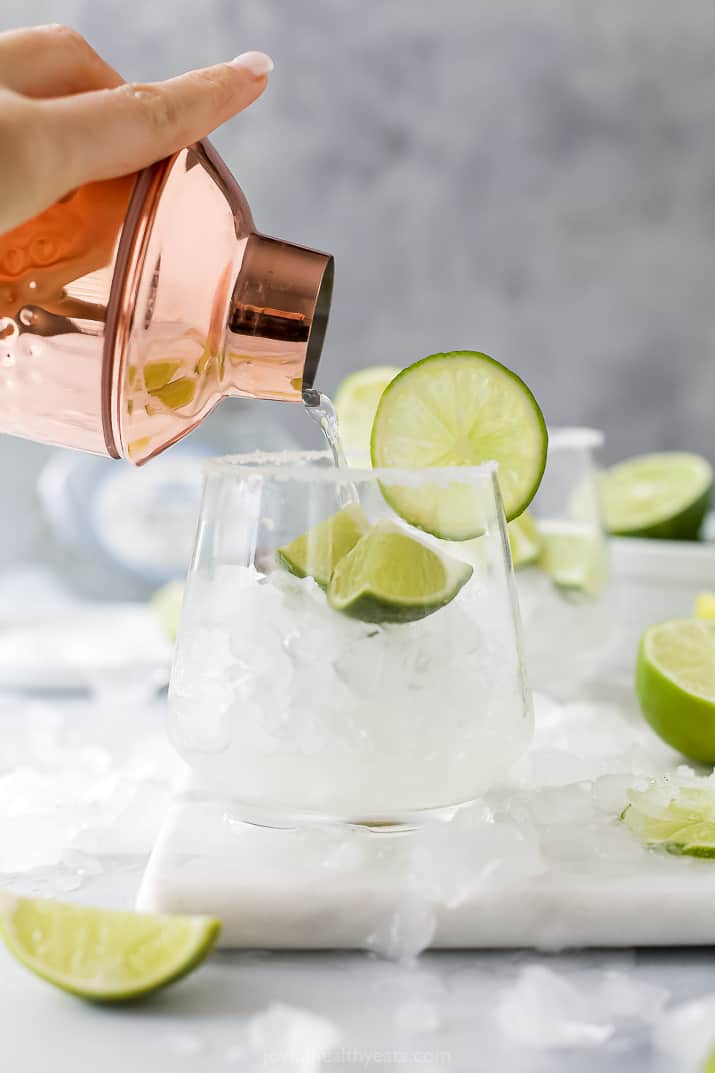 A Margarita Being Poured From the Cocktail Shaker to a Glass