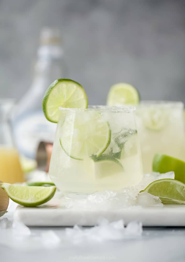 Two Glasses Filled with Homemade Margaritas and Pieces of Fresh Lime