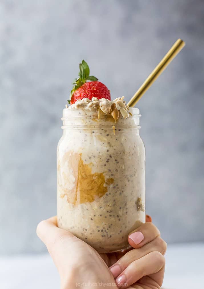 hand holding a jar with peanut butter oats