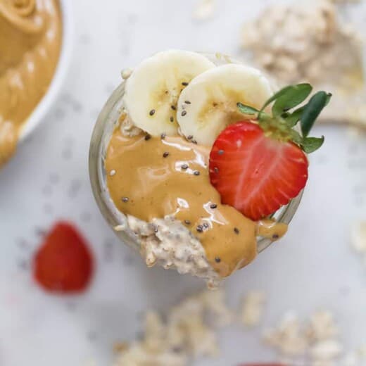 overhead photo of overnight oats with peanut butter, strawberry and banana