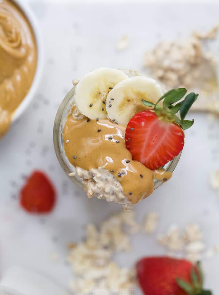 overhead photo of overnight oats with peanut butter, strawberry and banana