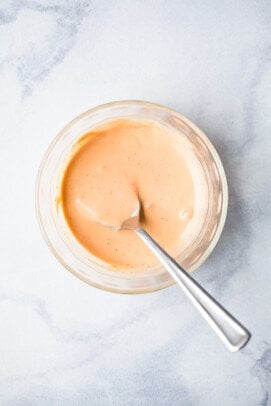 Sriracha mayo in bowl with spoon.
