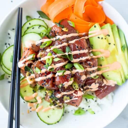 A Tuna Poke Bowl with a Pair of Black Chopsticks Balanced on the Bowl