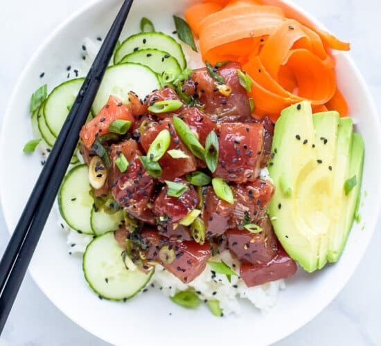 A Hawaiian Poke Bowl Sitting on Top of a Black and White Marble Counter