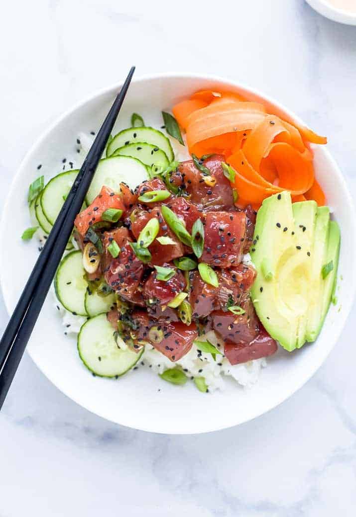 A Hawaiian Poke Bowl Sitting on Top of a Black and White Marble Counter