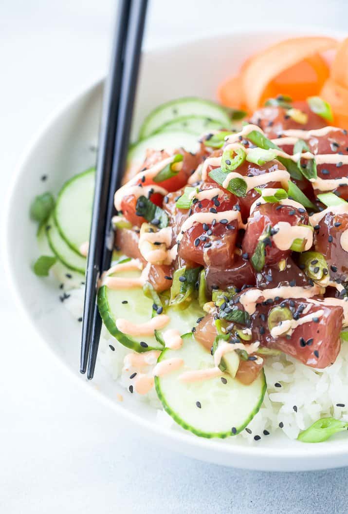 Rice, Bluefin Tuna, Sliced Cucumbers and More Veggies in a White Bowl