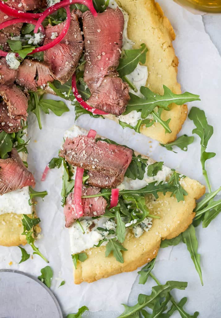 a slice of steak flatbread pizza