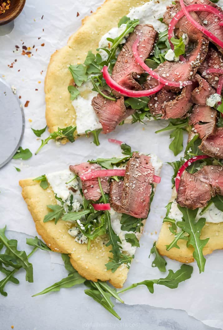 a piece of steak flatbread pizza