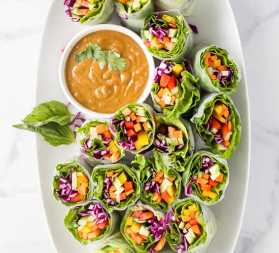 A Wide Platter Holding Fresh Summer Rolls and Spicy Peanut Butter Dip