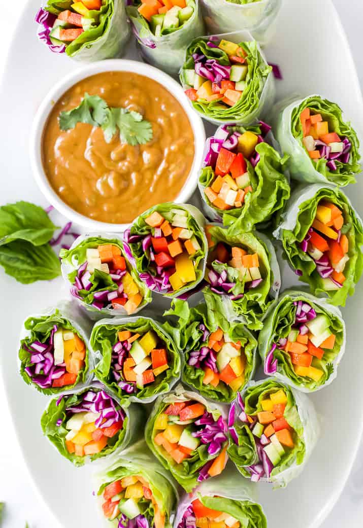 Veggie Rolls on a White Serving Plate with a Side of Peanut Dipping Sauce