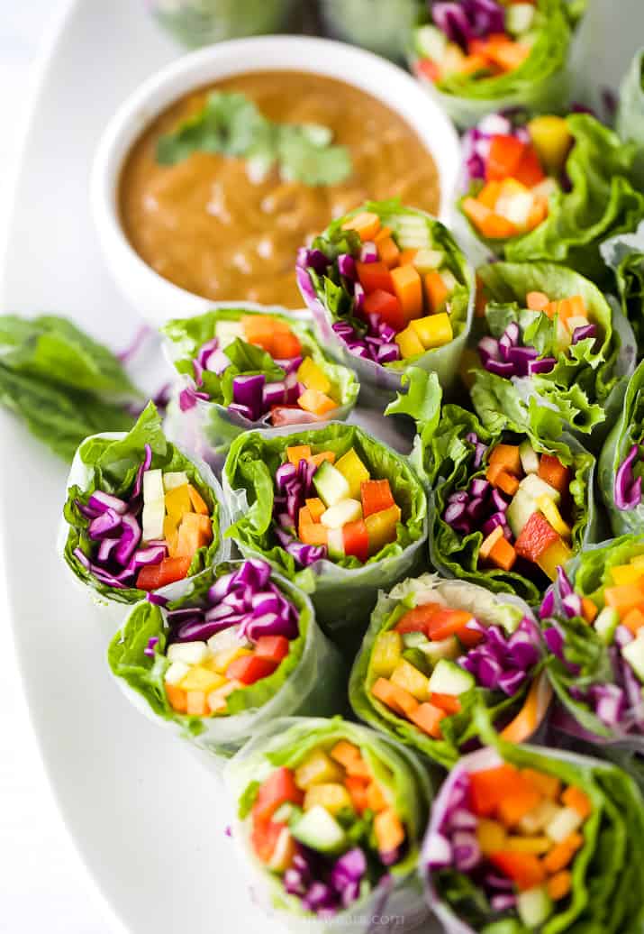 A Close-Up Shot of Summer Veggie Rolls with a Bowl of Peanut Sauce in the Background