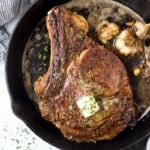 cowboy steak in a cast iron skillet with butter