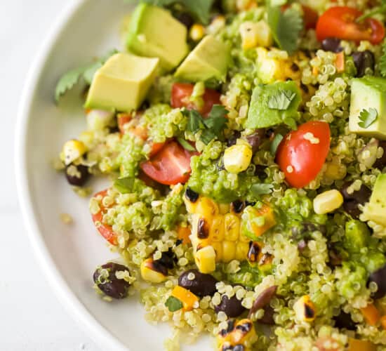Close-up of a serving of fiesta quinoa topped with avocado pieces