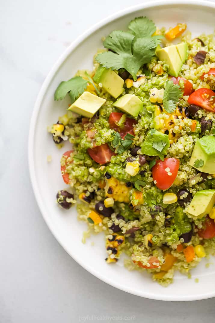 A plate of mexican quinoa salad topped with cilantro.