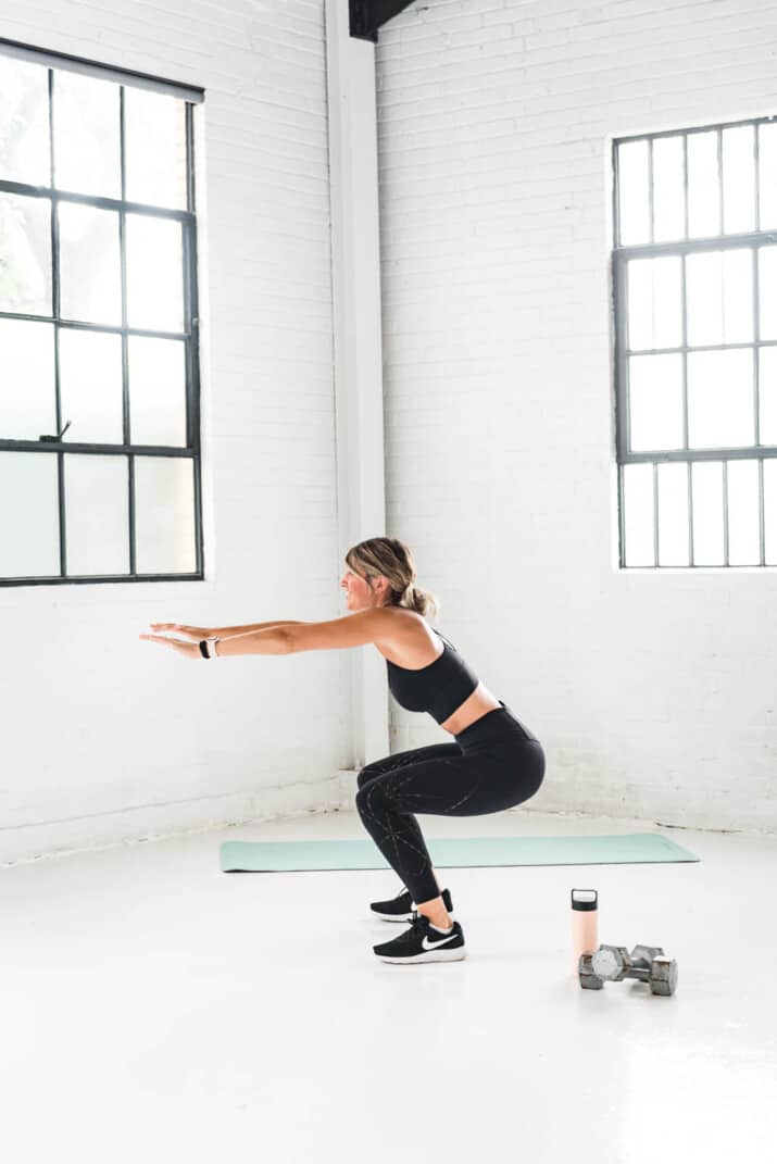 girl performing a squat exercise