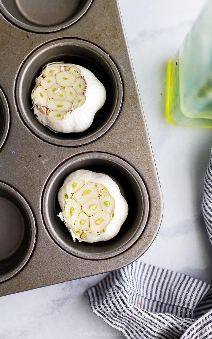 Heads of garlic in a muffin tin