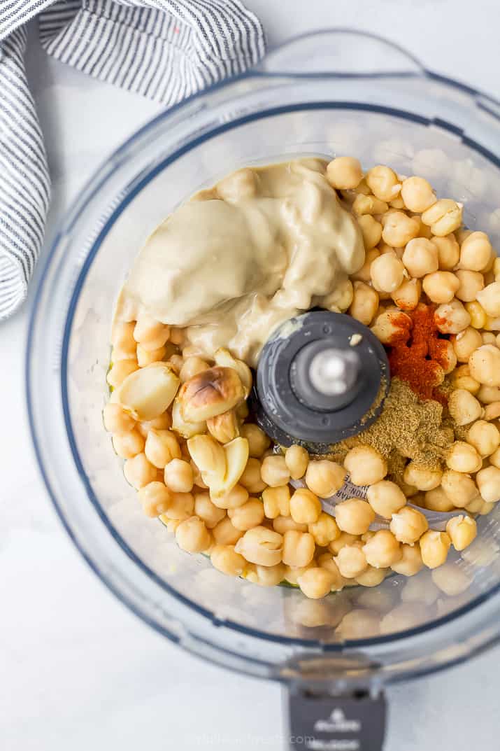 Ingredients for homemade hummus in a food processor bowl
