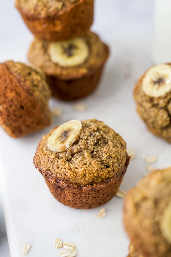 Maple Banana Oat Muffins topped with a slice of banana