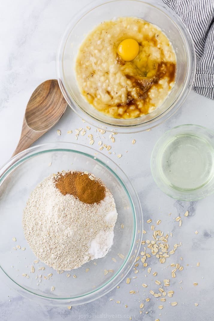 Two bowls with the wet and dry ingredients needed to make banana oat muffins