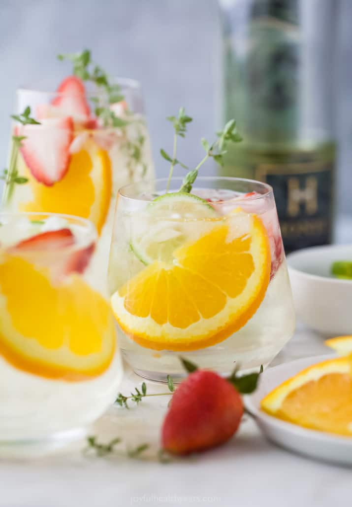 Glasses of white wine spritzer with orange slices