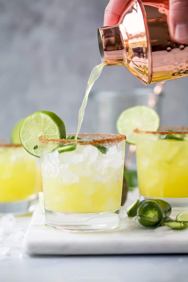 pouring margarita mix into a glass