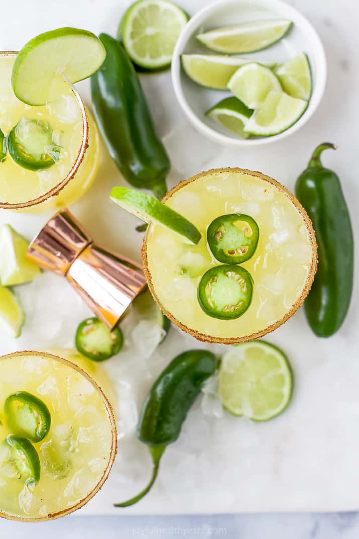 glasses filled with spicy margarita mixture and jalapenos