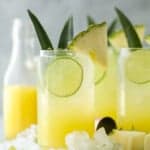 glass filled with pina colada spritzer with pineapple garnish