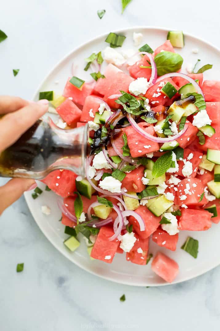 balsamic dressing poured on top of watermelon feta salad