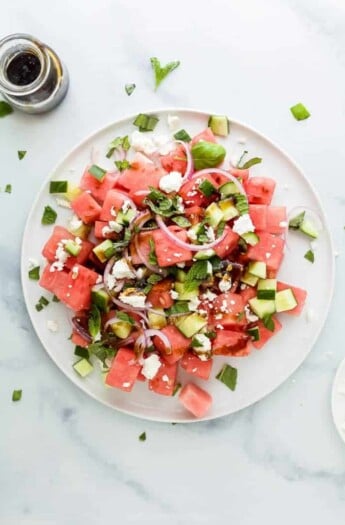 plate filled with watermelon feta salad with cucumber