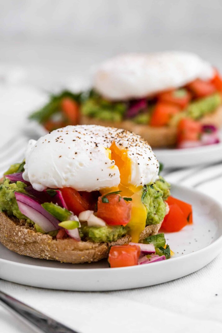 Two Servings of Eggs Benedict with Pico on Two Separate Plates