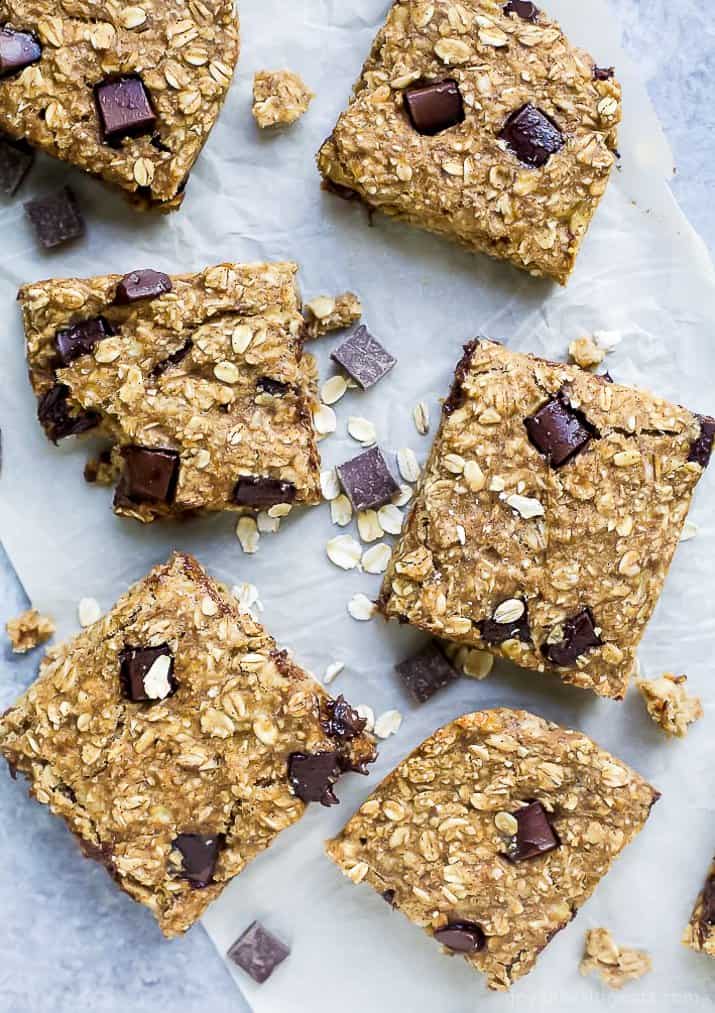 baked oatmeal bars lined up on parchment paper