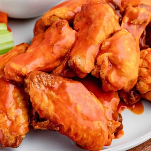 A Close-Up Shot of Spicy Baked Wings on a White Plate