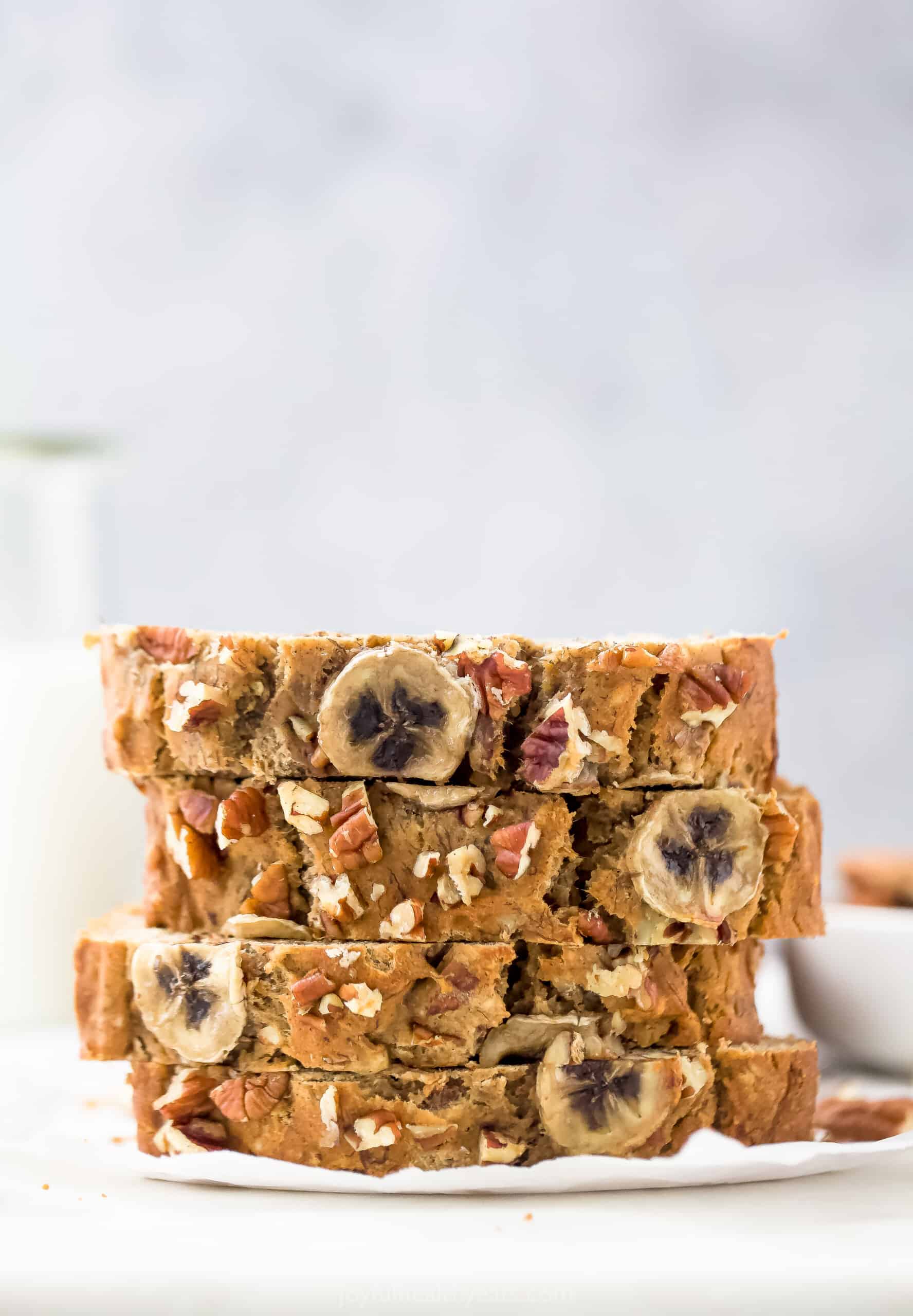 Four Slices of Banana Bread Stacked on Top of Each Other Over a Napkin