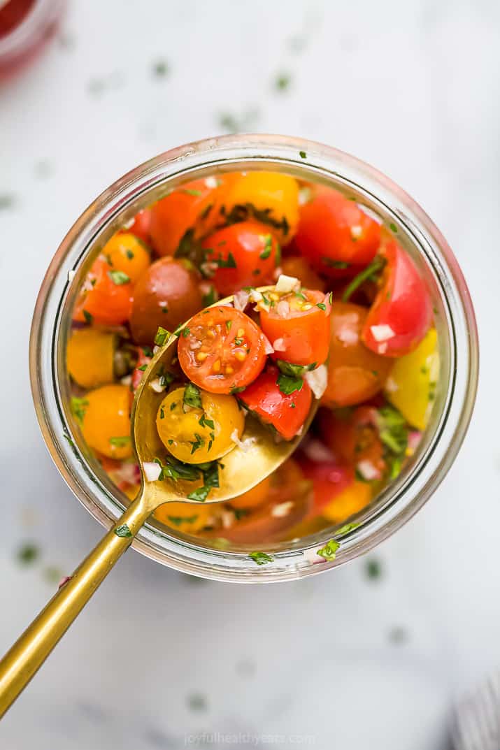 spoon scooping tomato salad