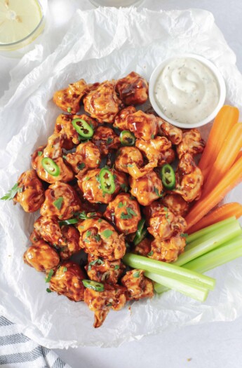 air fryer cauliflower wings tossed with honey bbq sauce in a basket