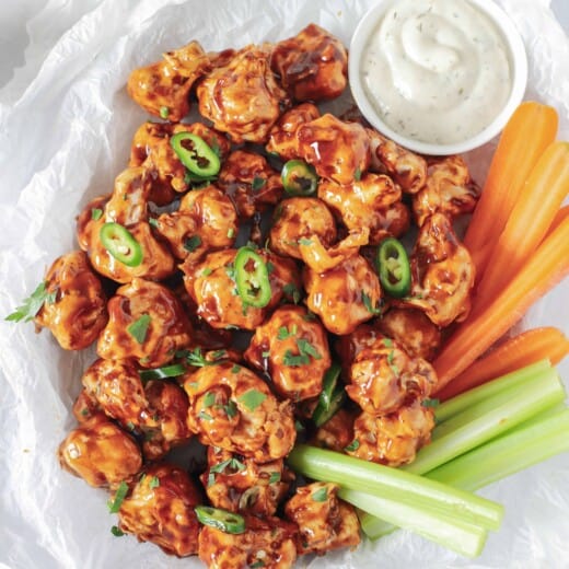 air fryer cauliflower wings tossed with honey bbq sauce in a basket