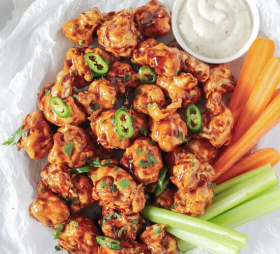 air fryer cauliflower wings tossed with honey bbq sauce in a basket